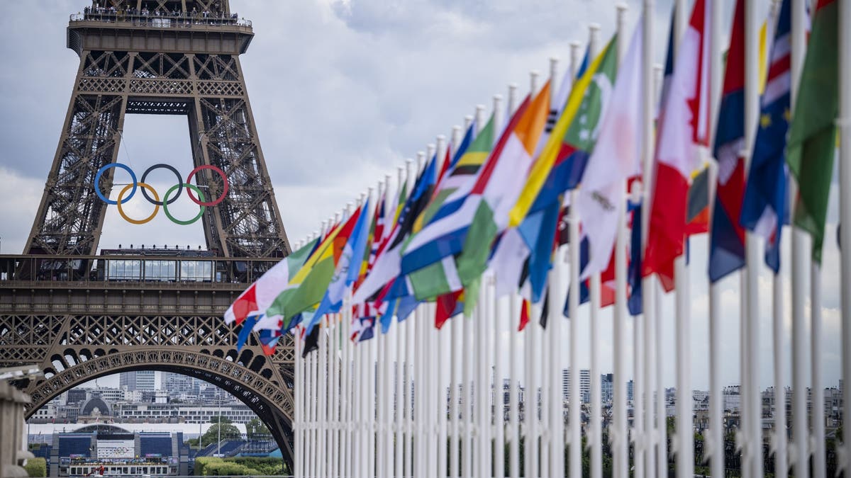 A view of the Eiffel Tower with the Olympics rings pictured with national flags of competing countries from the Place du Trocadero ahead of Paris 2024 Olympic Games on July 21, 2024 in Paris, France. (Photo by Kevin Voigt/GettyImages)