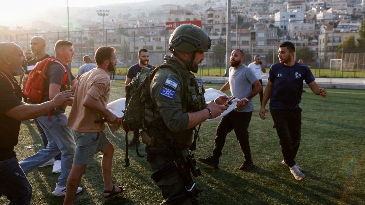 Israeli security forces and medics transport casualties from a site where a reported strike from Lebanon fell in Majdal Shams village in Israel on July 27, 2024. (Photo by JALAA MAREY/AFP via Getty Images)