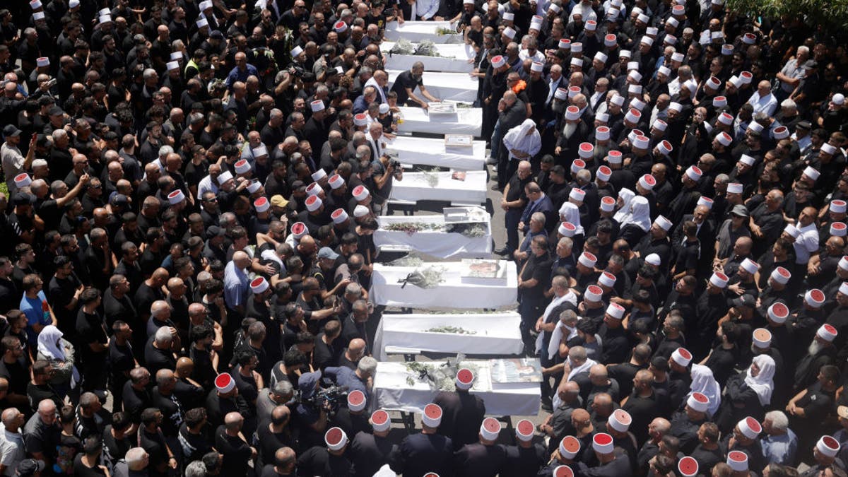 Mourners attend a funeral held on July 28, 2024 for 10 of the victims of yesterday's rocket attack in Majdal Shams. Twelve young people were killed in a rocket attack on a soccer pitch in this Druze Arab community. Israel blamed the Iran-backed terror group Hezbollah for the attack.