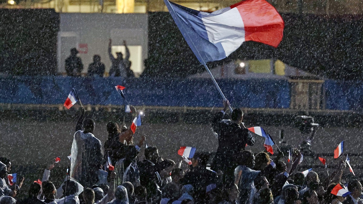 French athletes at Olympic games wave French flag