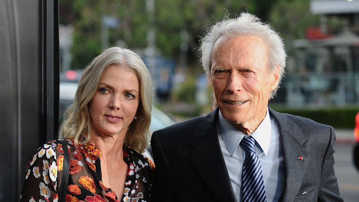 Clint Eastwood and Christina Sandera walking togehter