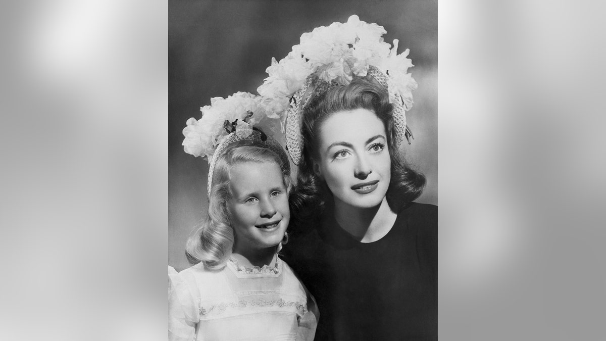 Joan Crawford in a matching headdress with Christina Crawford