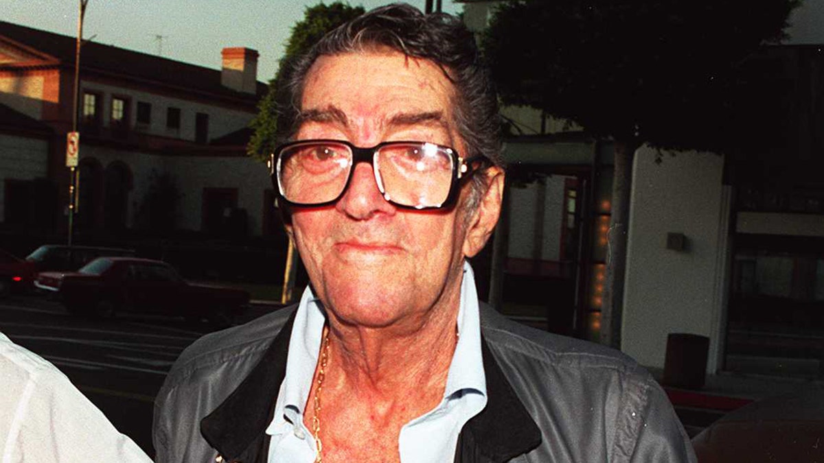 A close-up of Dean Martin wearing his blue jacket and glasses.