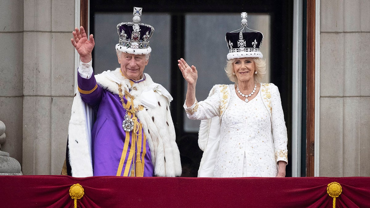 King Charles and Queen Camilla waving to the public from the balcony of Buckingham Palace after they were crowned.