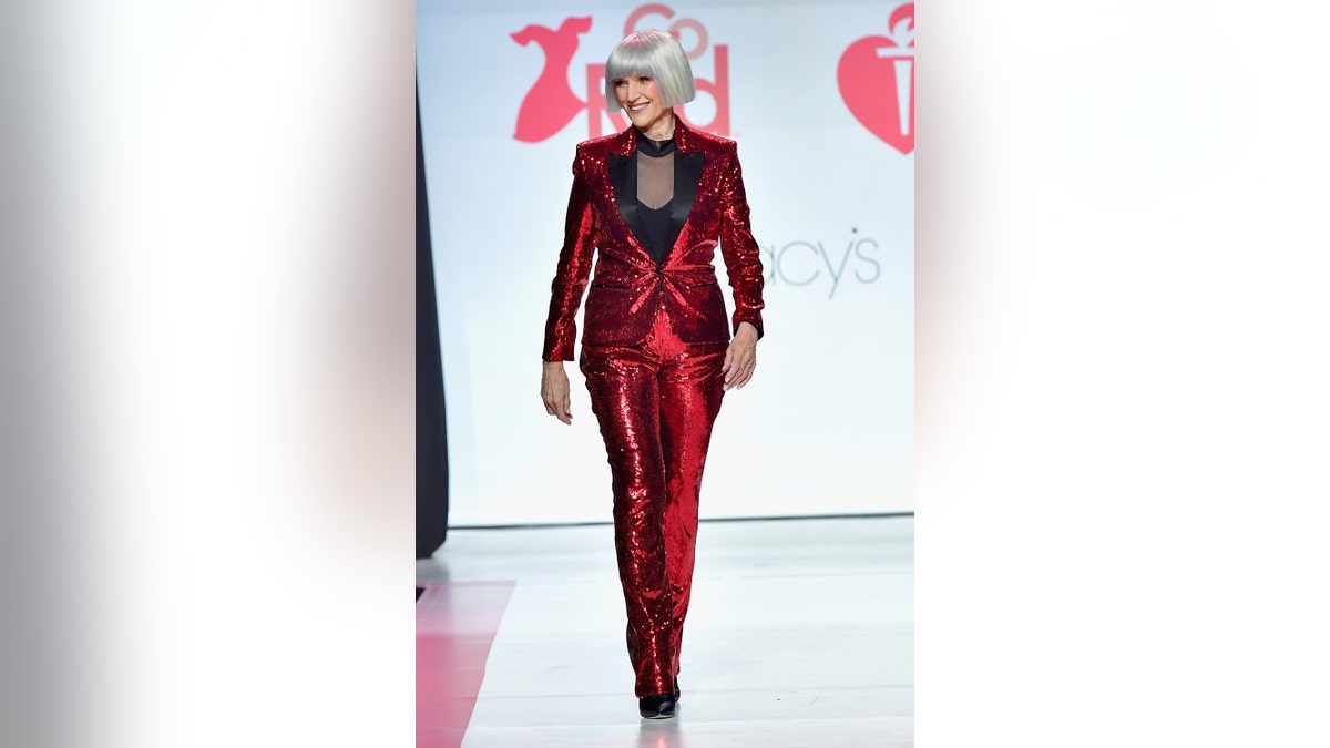 Maye Musk wearing a sparkling red suit on the carpet