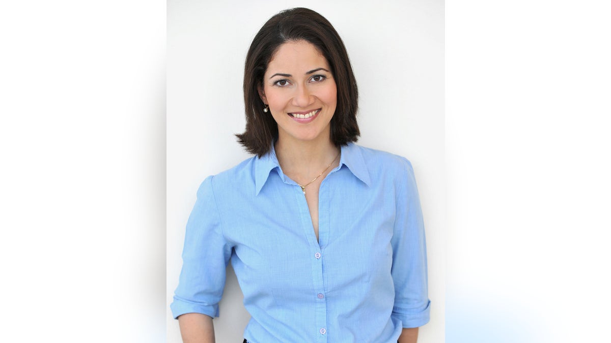 Mishal Husain smiling and wearing a sky blue blouse.