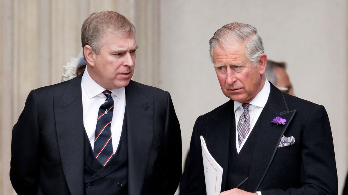 Prince Andrew speaking to King Charles as he looks concerned.