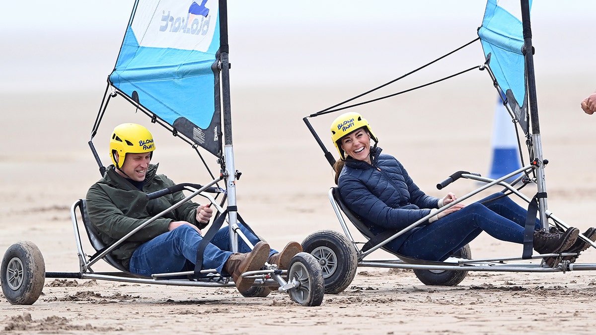 Prince William and Kate Middleton laughing as they compete in yachting.