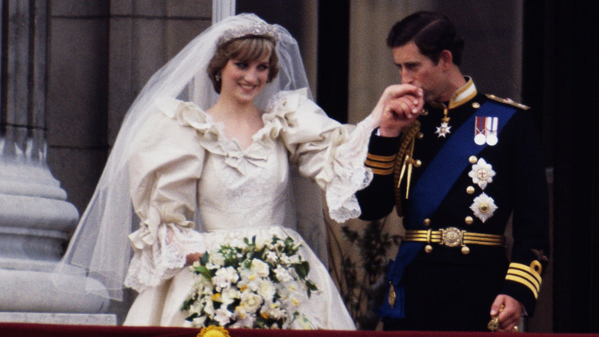 Prince Charles kissing Princess Dianas hand on their wedding day.
