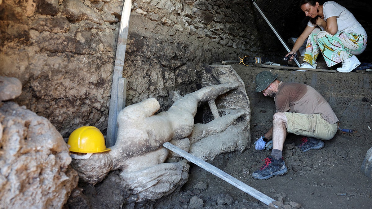 Statue of Greek god uncovered by archaeologists during excavation of ...