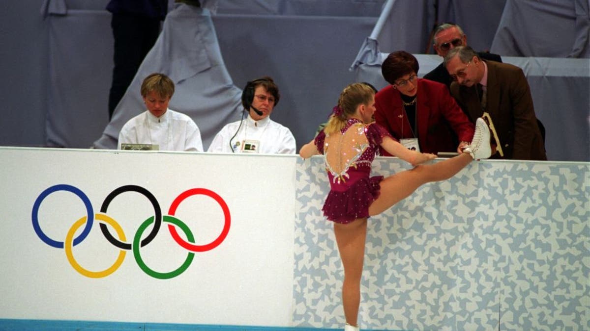 Tonya Harding with a boot on the judge's stand showing a broken lace