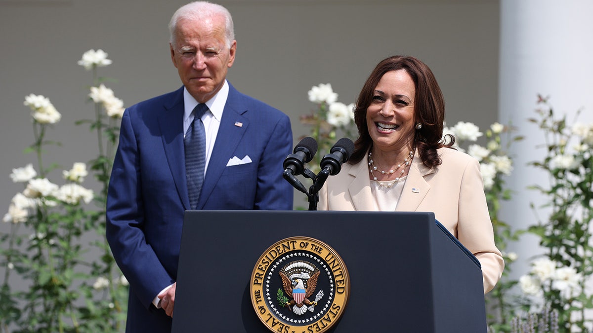 U.S. Vice President Kamala Harris delivers remarks as U.S. President Joe Biden looks on