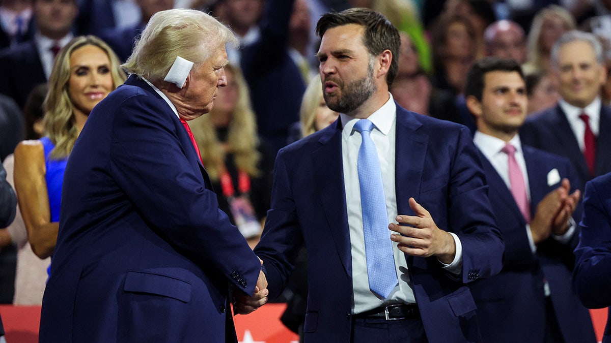 Republican presidential nominee and former U.S. President Donald Trump greets Republican vice presidential nominee J.D. Vance as he attends Day 1 of the Republican National Convention