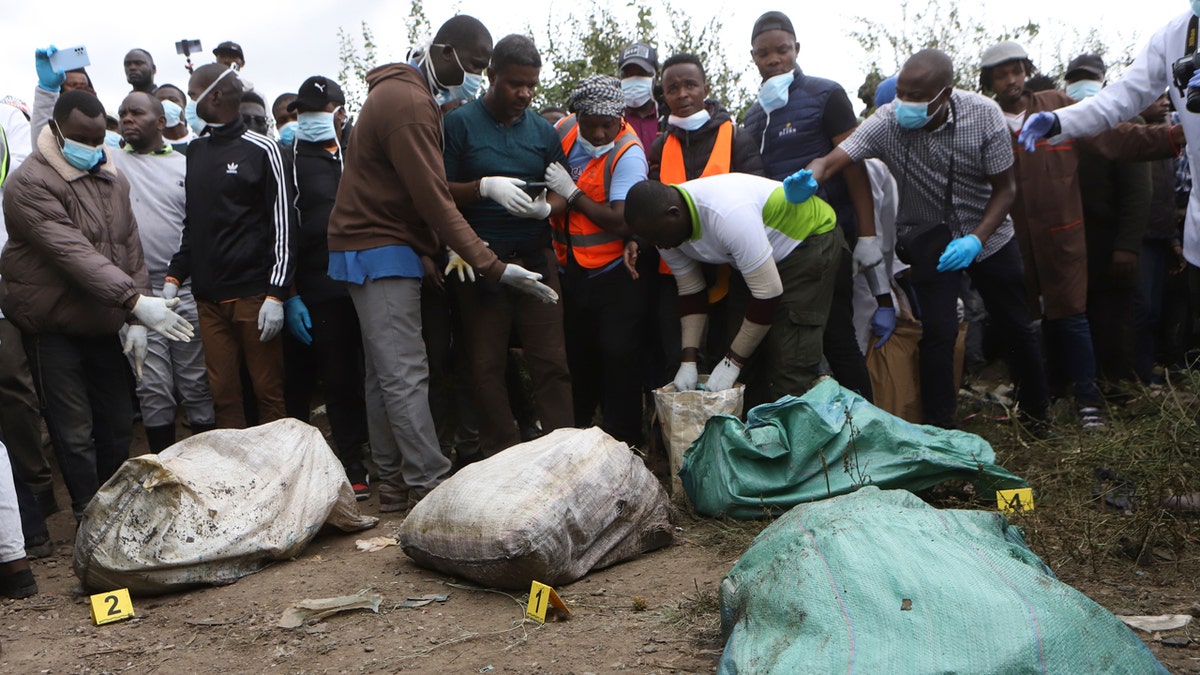Sacks with human remains are seen after being removed from a quarry in Kenya.