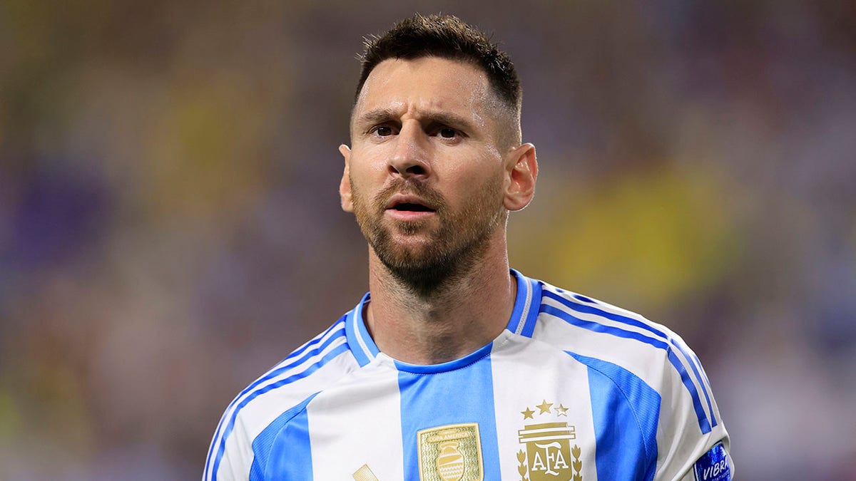 Lionel Messi looks on