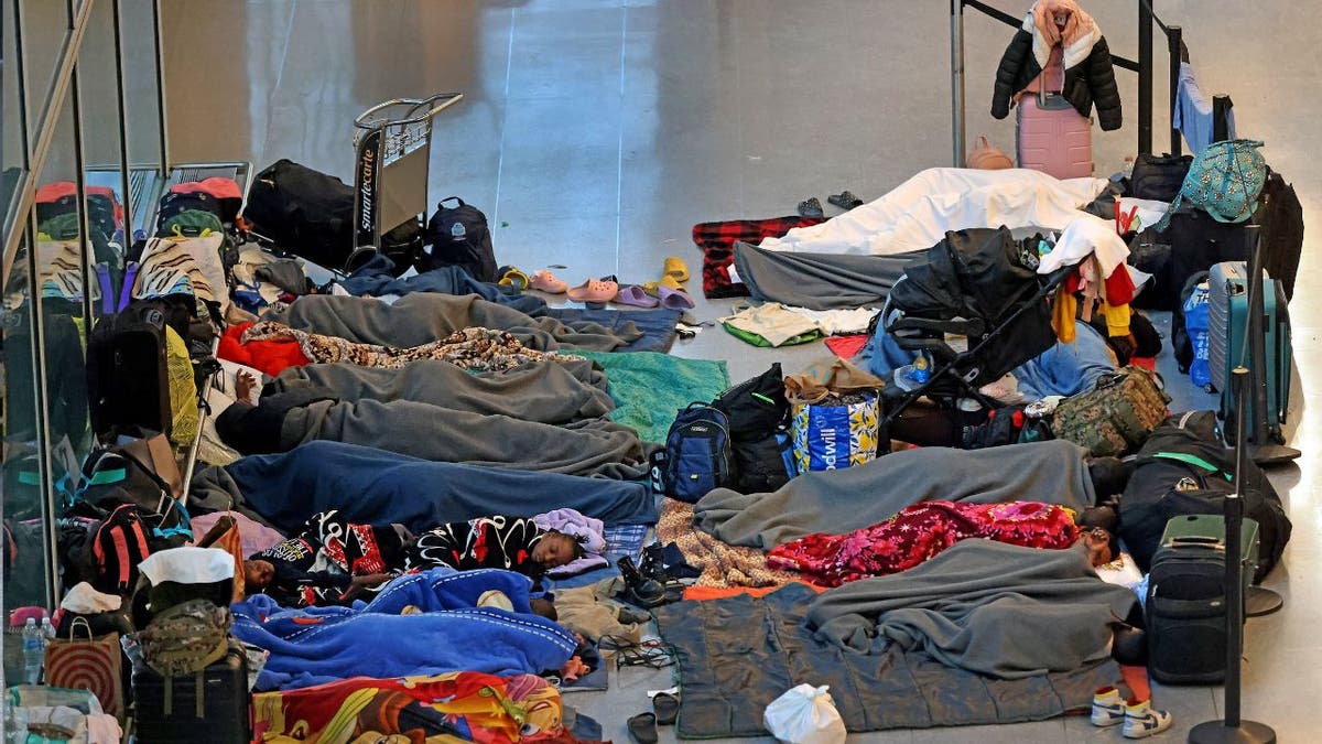 Migrants sleeping on the floor at Logan Airport