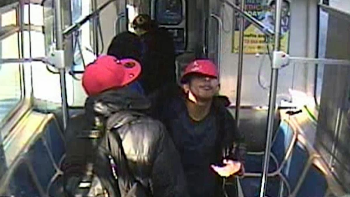 Two migrants in red caps following an attack on a man on a train