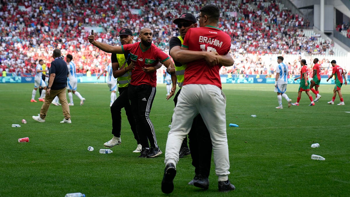 Bottles scattered across the pitch