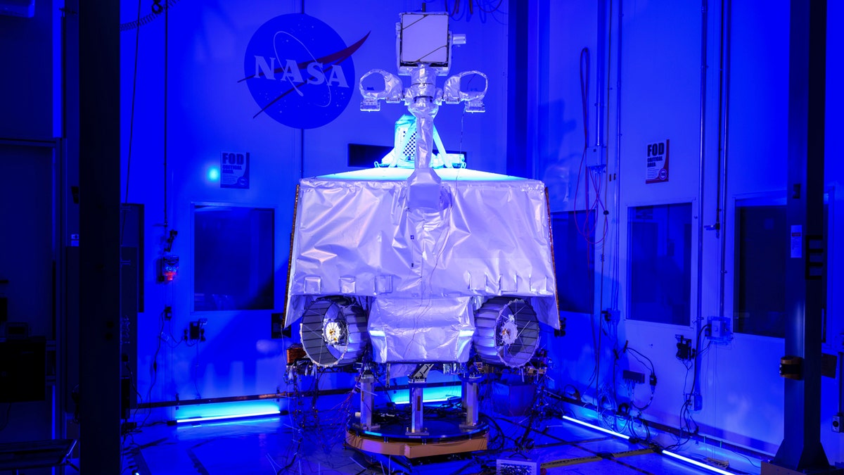 NASA's Viper moon rover is seen under blue lights at the Johnson Space Center.