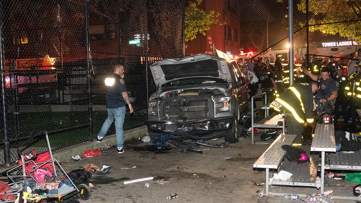 Police investigate a crash scene with a white truck in a park