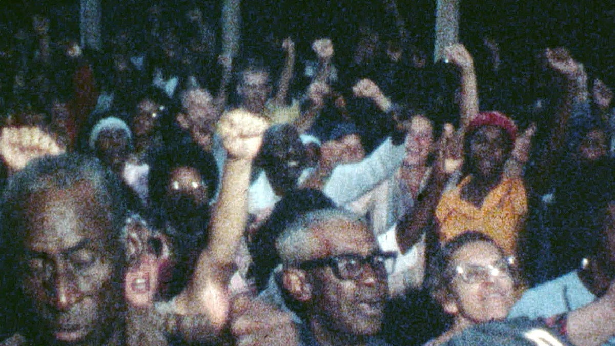 Peoples Temple members congregate during an event in Jonestown, Guyana.