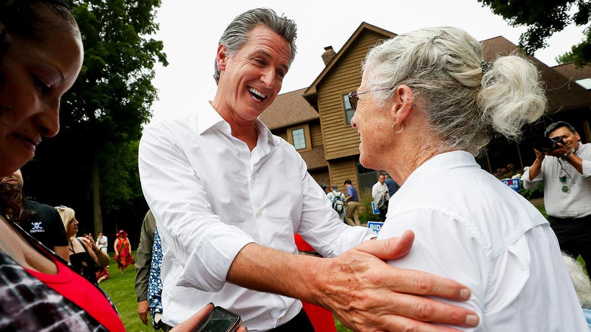 Gavin Newsom talking to event attendee