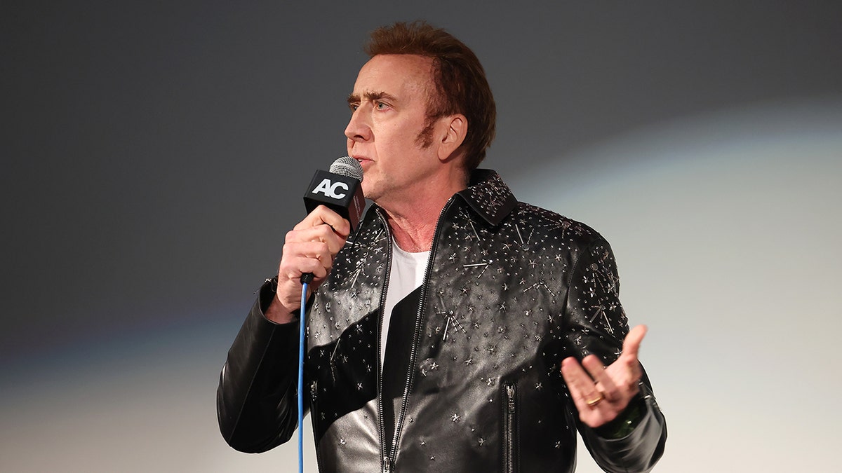 Nicolas Cage holding a microphone
