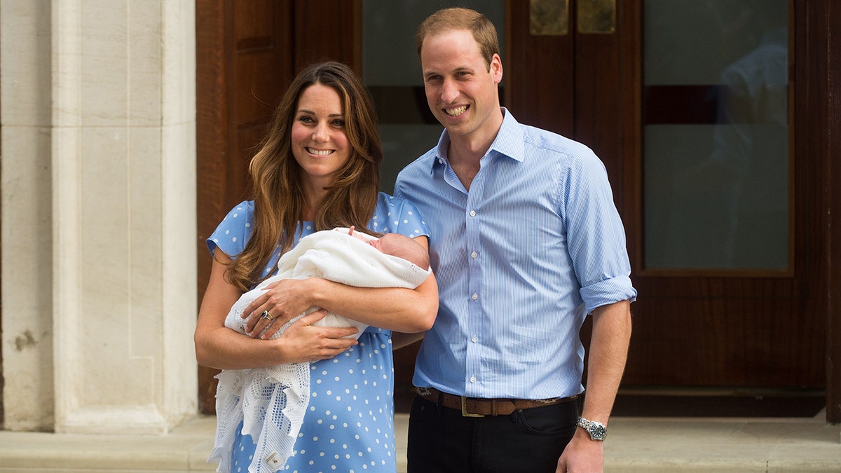 Princess Catherine, Prince William and Prince George on the steps in front of the hospital.
