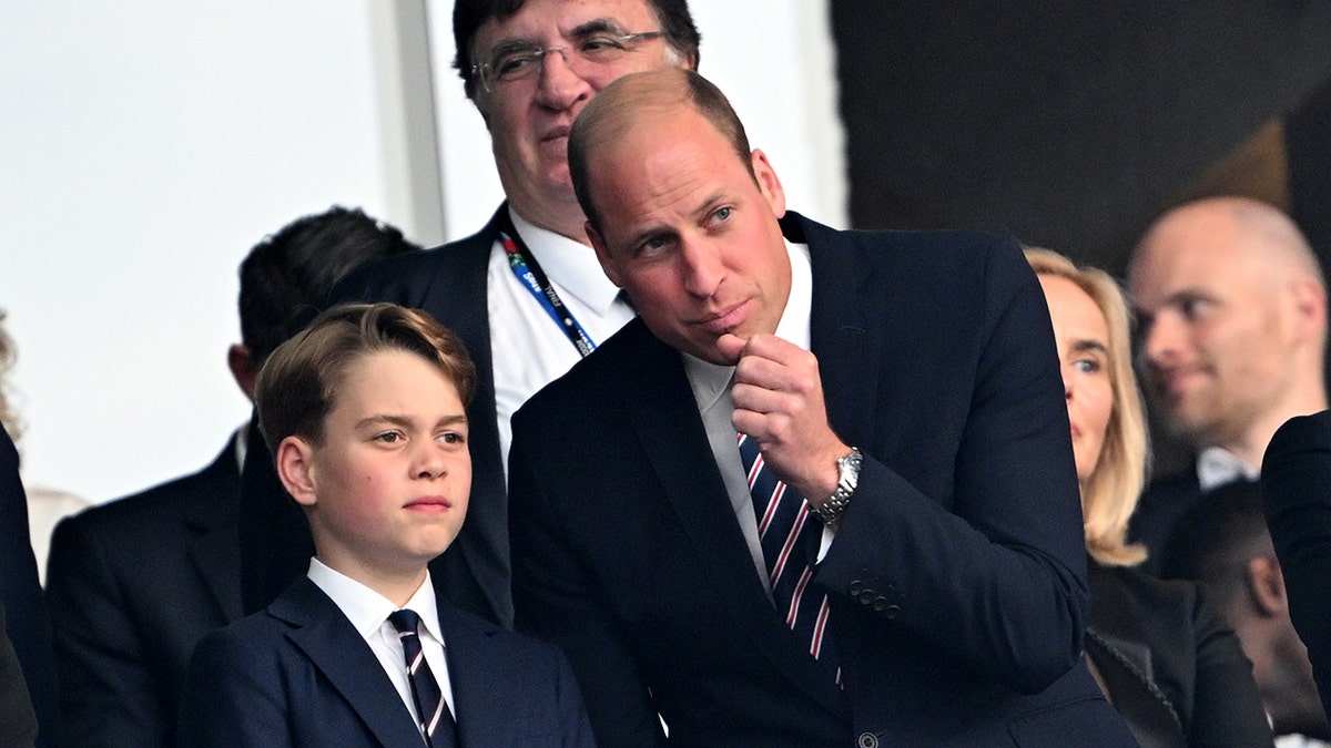 Prince George and prince William take in a soccer match