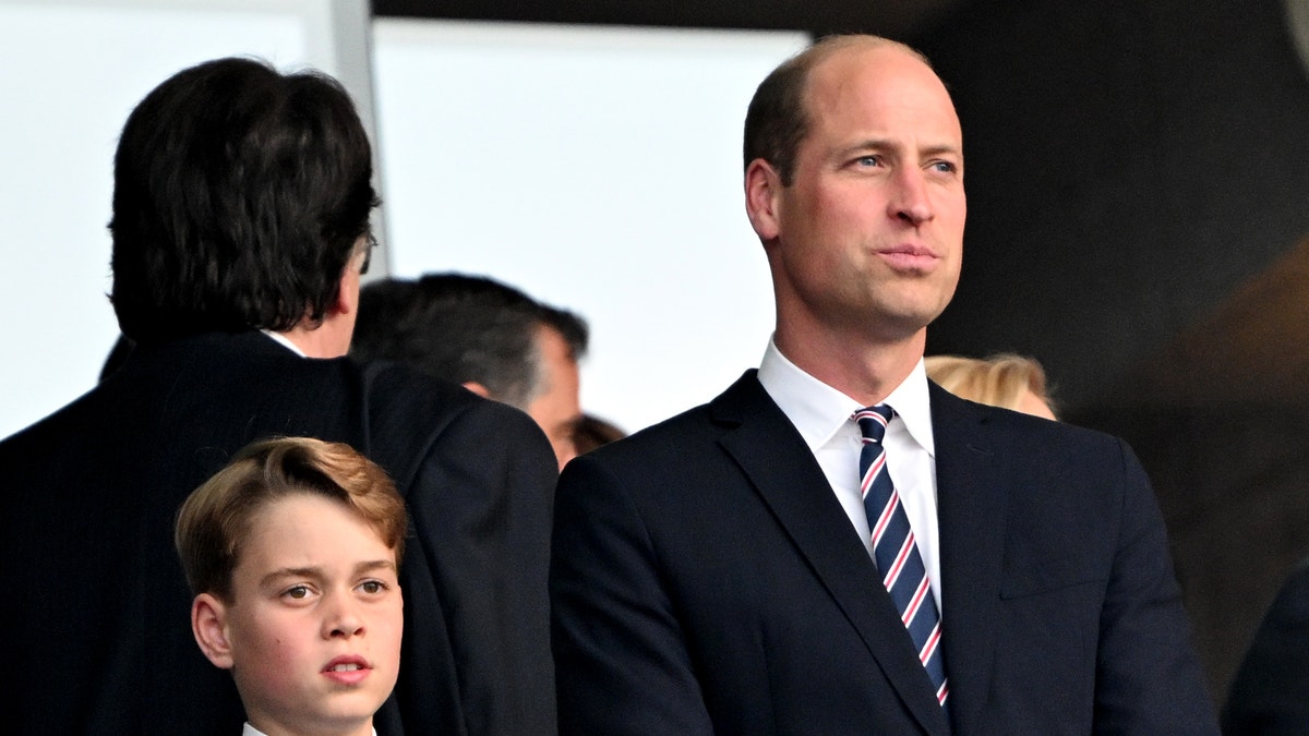 Prince William and son Prince George wore matching dark suits for the game.