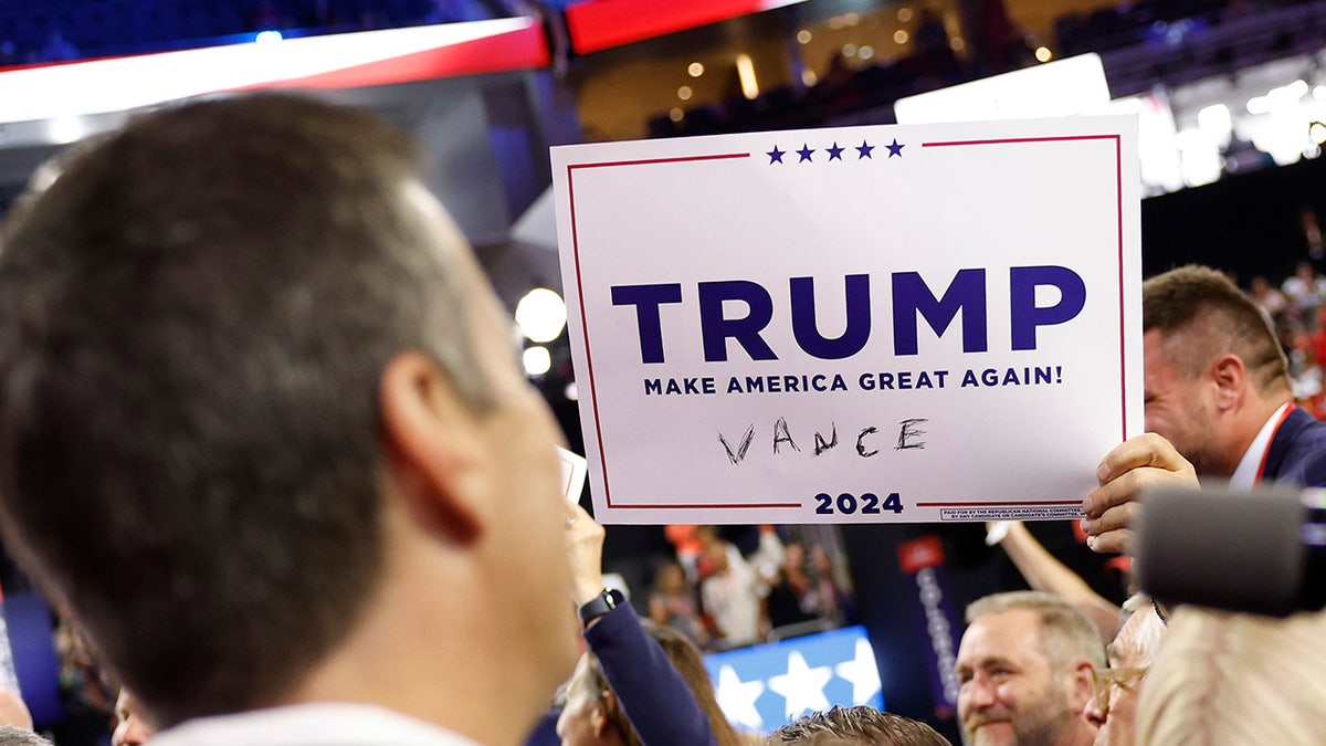 A person holds a sign endorsing Republican presidential candidate, Donald Trump