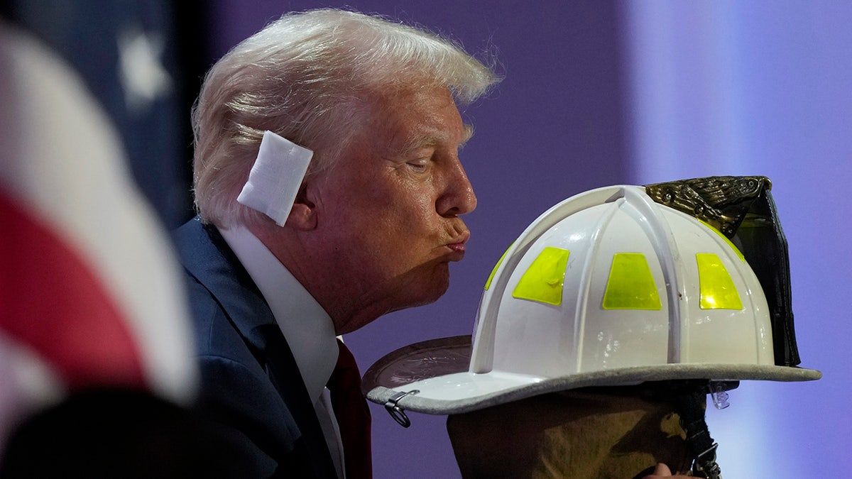 Donald Trump kisses the helmet of Corey Comperatore during the Republican National Convention