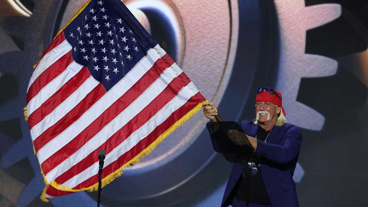 Hulk Hogan waves a U.S. flag as he takes the stage on Day 4 of the Republican National Convention