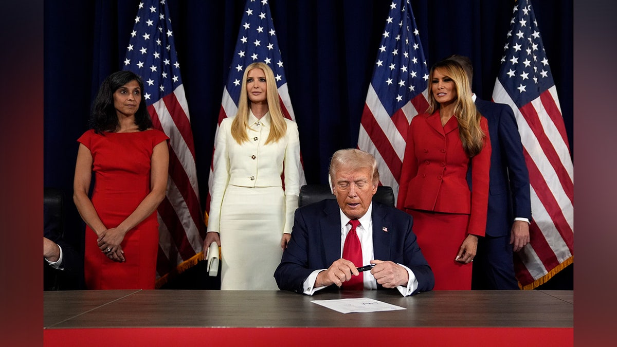 As Usha Chilukuri Vance, Ivanka Trump, and former first lady Melania Trump watch, Republican presidential candidate former President Donald Trump and Republican vice presidential candidate Sen. JD Vance, R-Ohio, sign paperwork to officially accept the nominations during the final day of the Republican National Convention