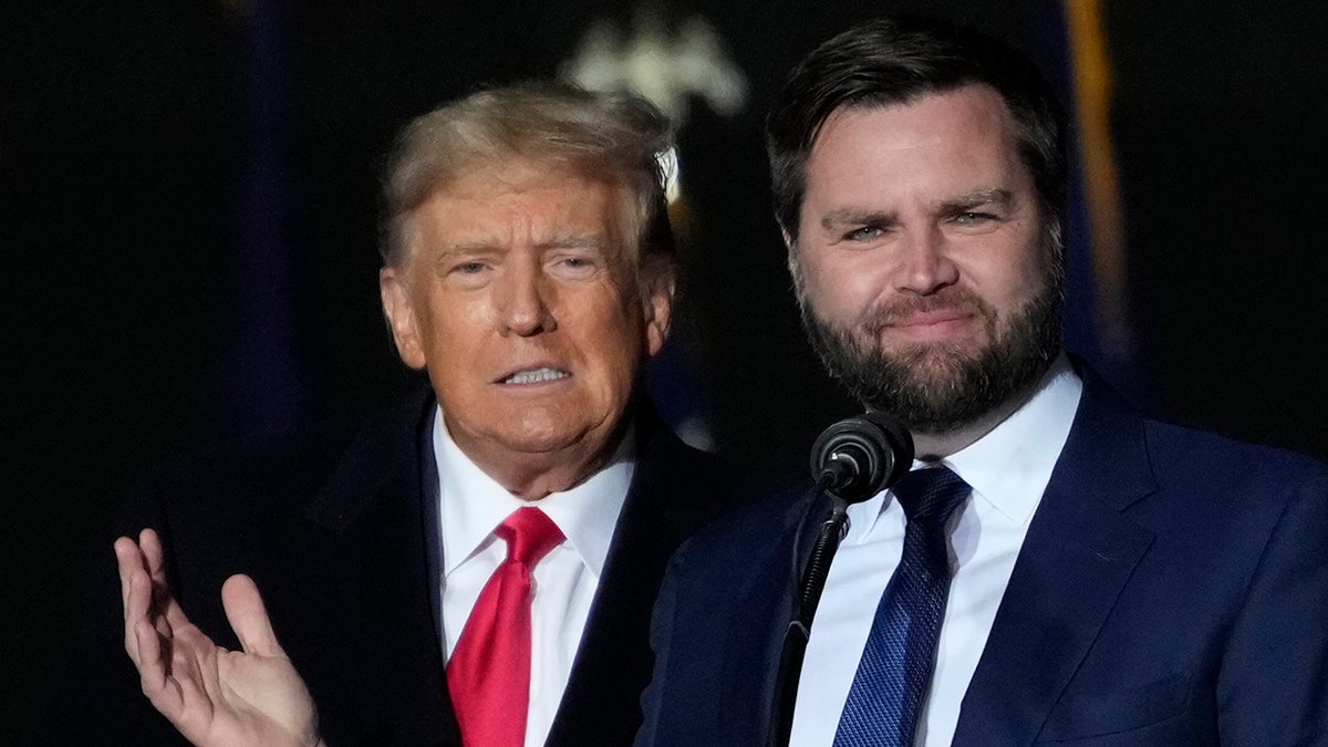 Former U.S. President Donald Trump and JD Vance greet supporters during the rally