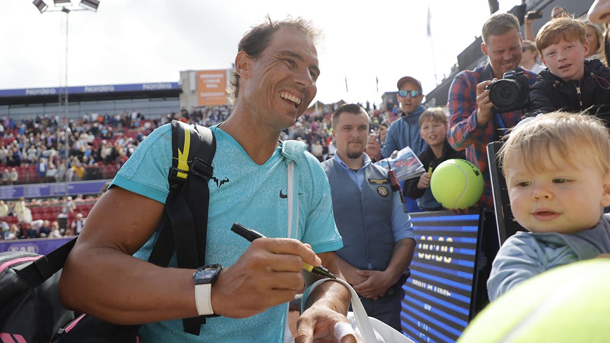 Rafael Nadal signs autographs