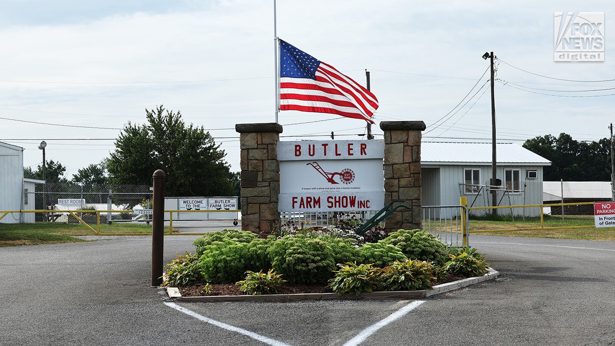A flag is lowered to half-mast at the front entrance of the Butler Farm Show in Butler, Pennsylvania