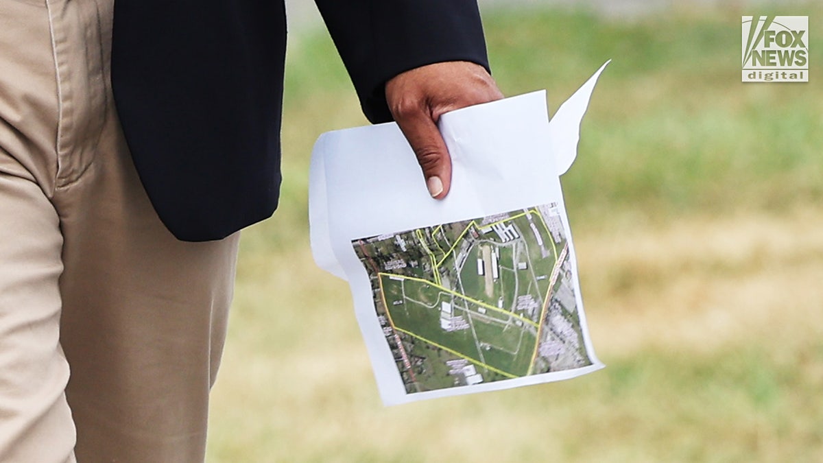 Rep. Glenn Ivey (D-MD carries a map of the Butler Farm Show in Butler, Pennsylvania
