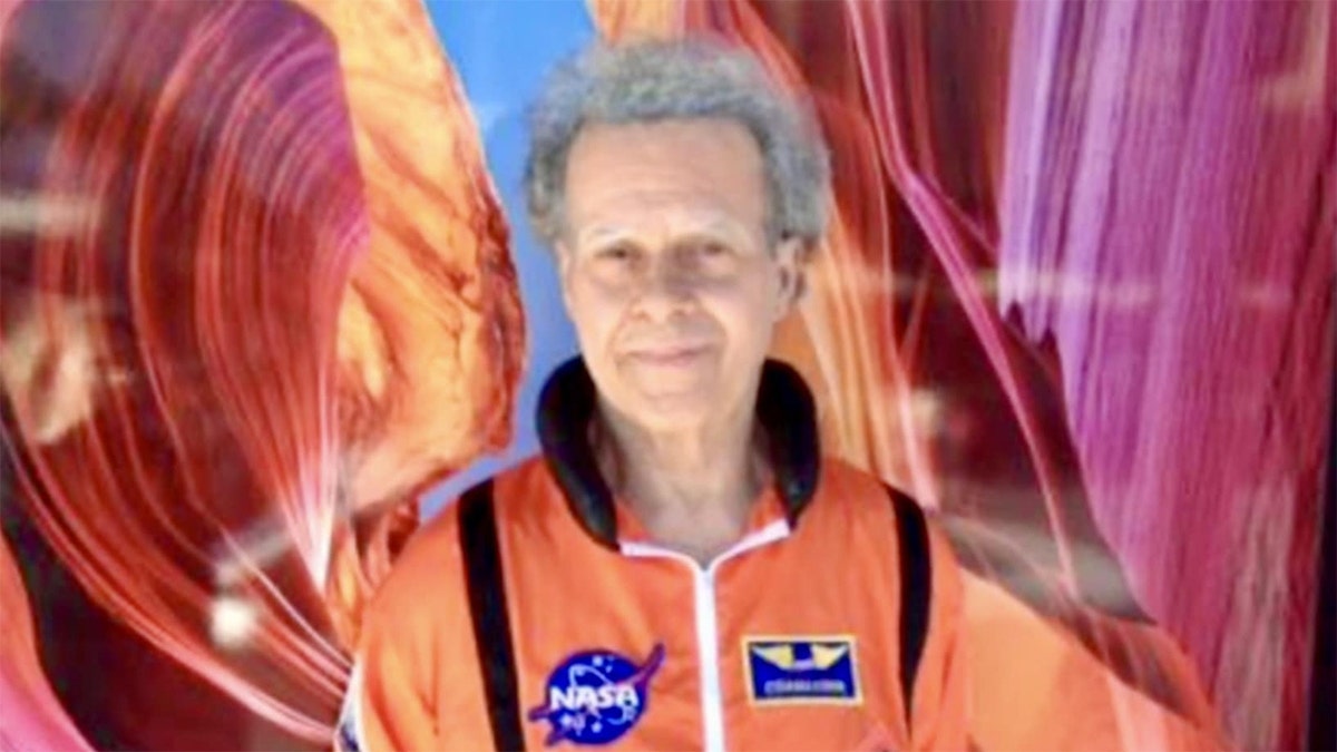 Richard Simmons in an orange NASA costume