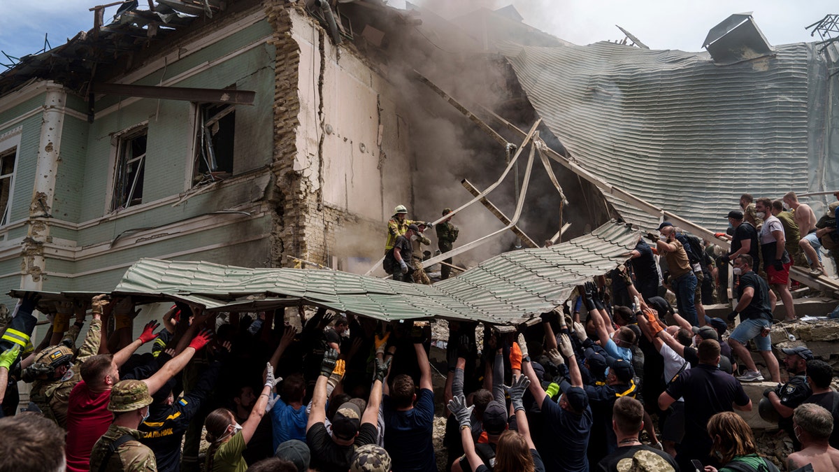 Emergency services work at the site of Okhmatdyt children’s hospital hit by Russian missiles.