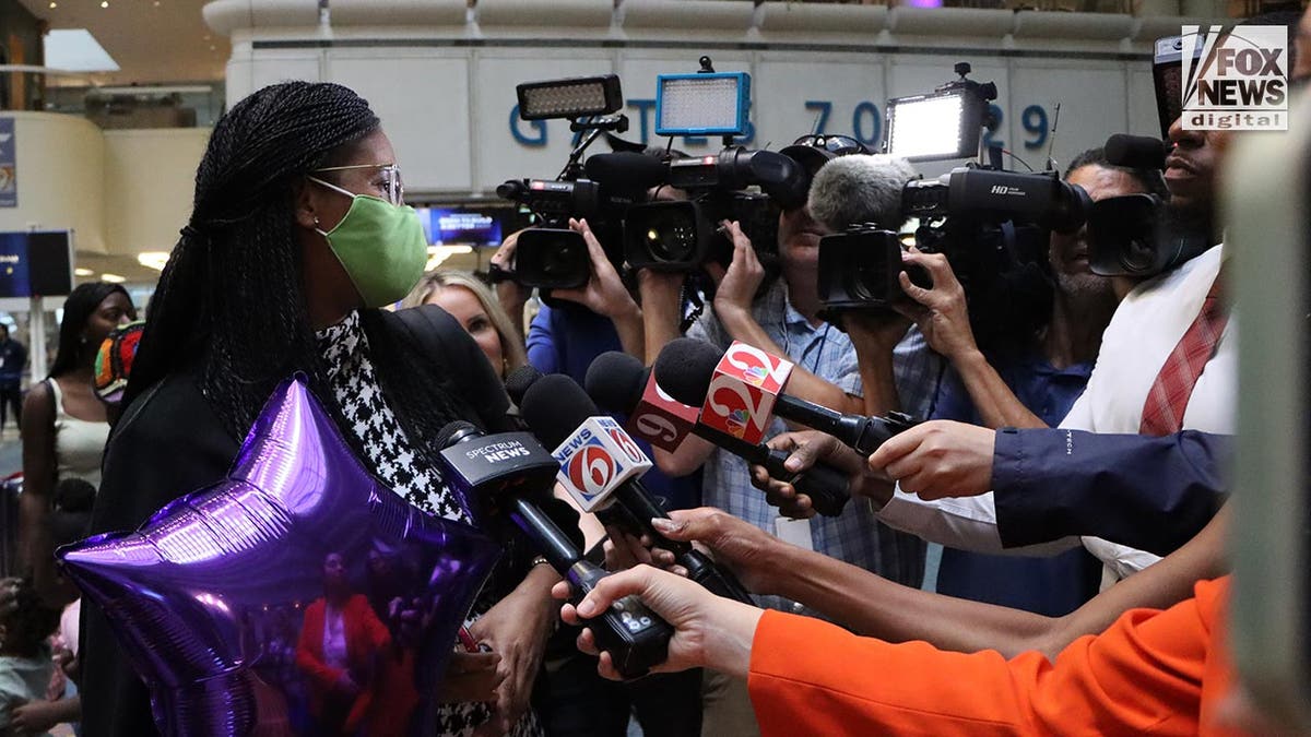 Sharitta Grier talks to reporters