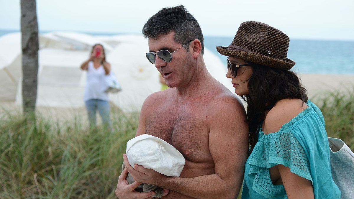 Simon Cowell his infant son Eric with Lauren Silverman