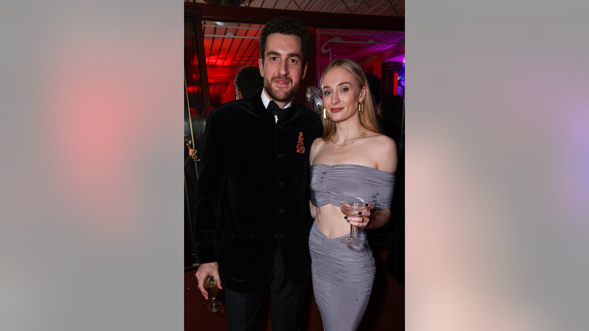 Sophie Turner and Peregrine Pearson posing for photo