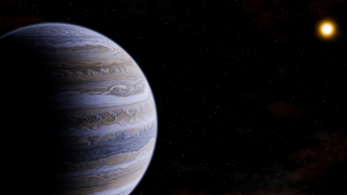 A cold gas giant planet, similar to Jupiter, is depicted orbiting a red dwarf star.