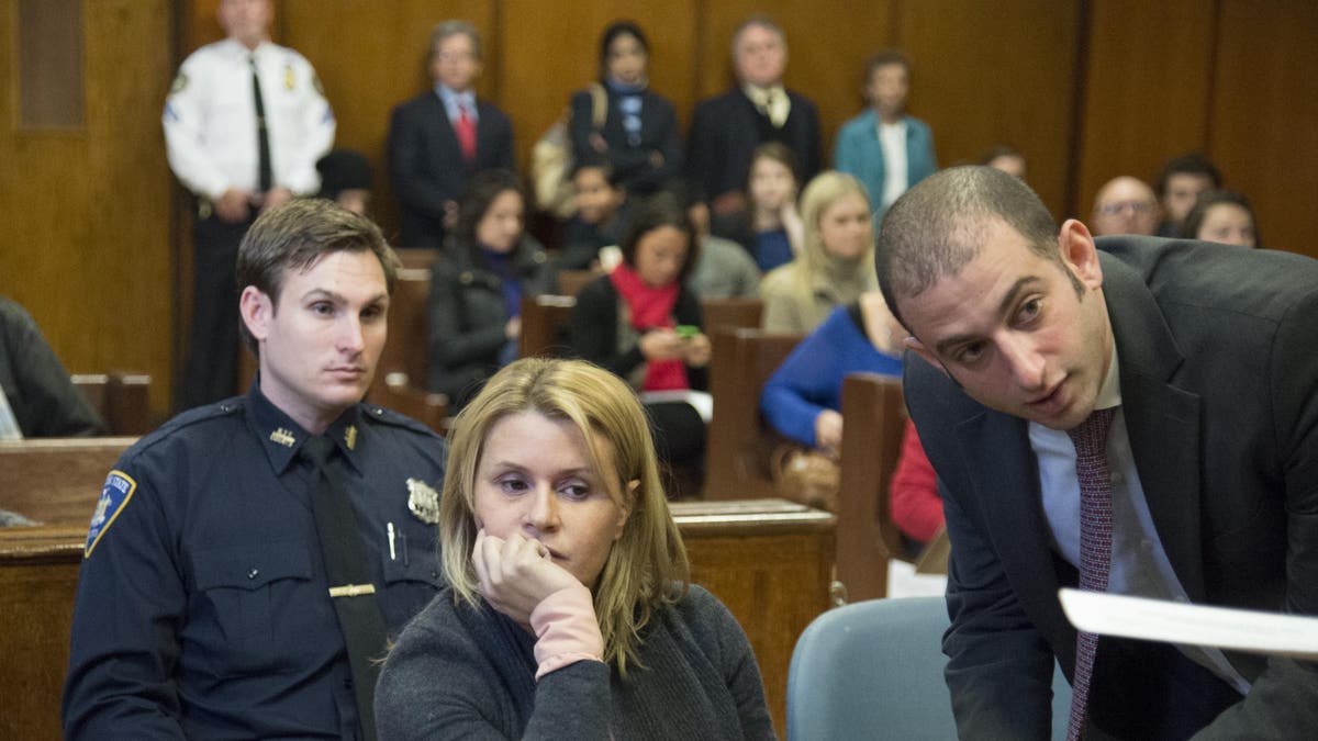 Attorney stand with his client at the defense table.