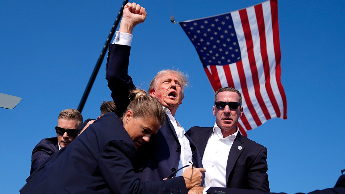 Former President Trump is surrounded by U.S. Secret Service agents at a campaign rally