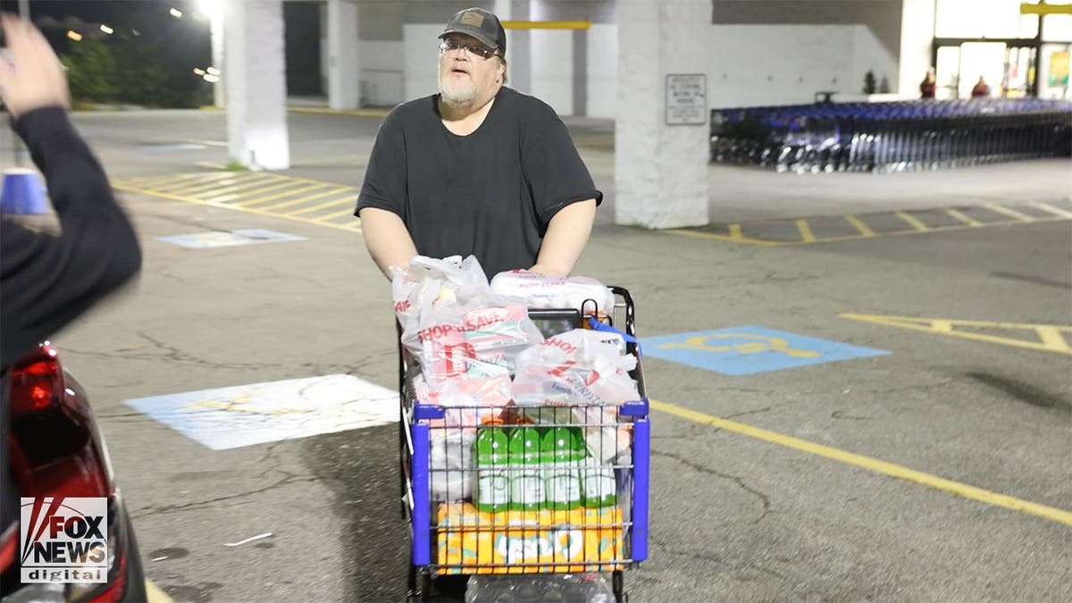 Trump assassin's father Thomas Crooks with a full shopping cart in the carpark of a supermarket.