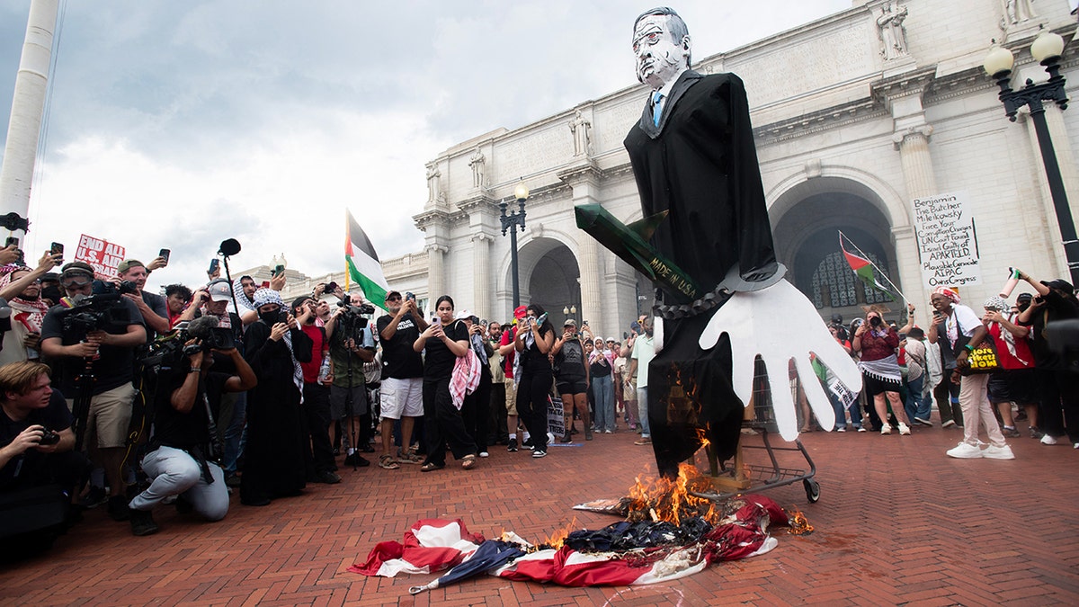 US flag burning on ground at anti-Israel protest at Union Station