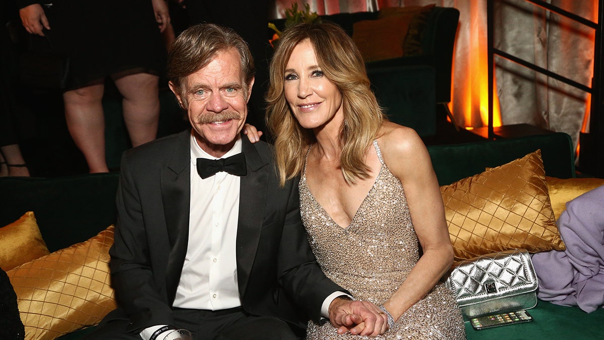 William H Macy and Felicity Huffman sitting together and smiling