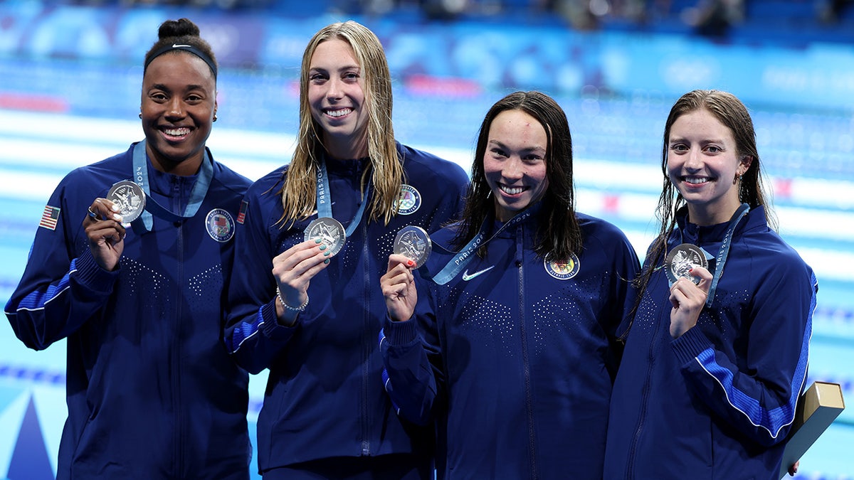 Team USA swimmers pose with silver medals